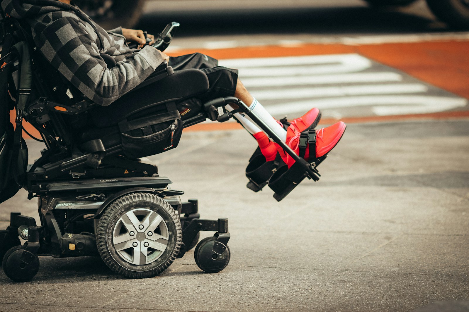 man in brown jacket and black pants riding black and red motorcycle, Disability